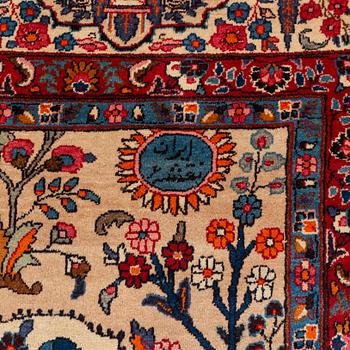 A carpet, semi-antique, Mashad, figural, ca 402 x 298 cm.