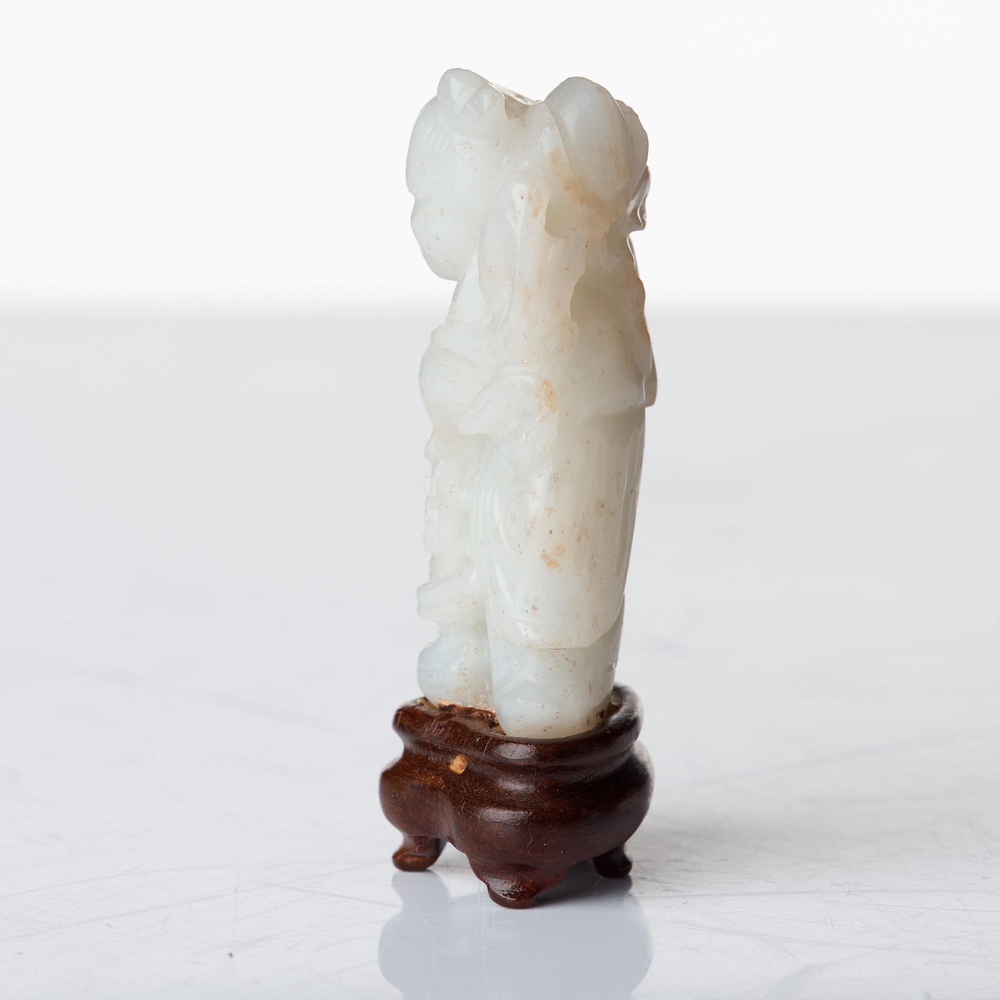 A sculptured nephrite belt buckle, figurine and brush washer, late Qing dynasty.