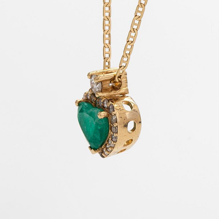 An 18K gold necklace and pendant with heart-shaped emerald and diamonds.