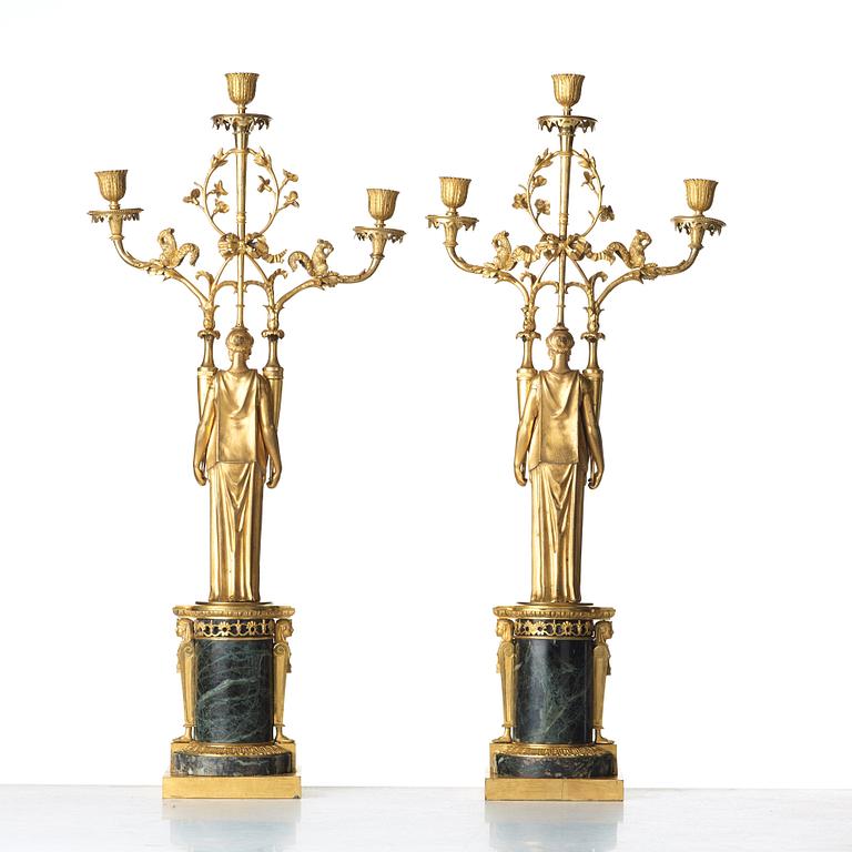 A pair of French Directoire three-light candelabra, circa 1800.