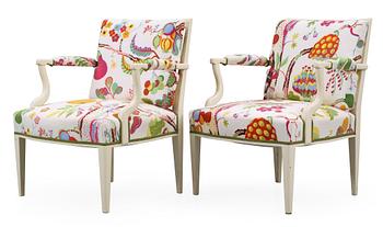 A pair of Josef Frank white lacquered and rattan armchairs by Svenskt Tenn.