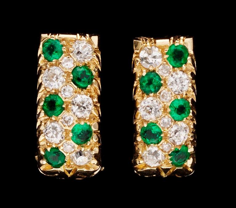 A pair of gold, emerald and diamond earrings.
