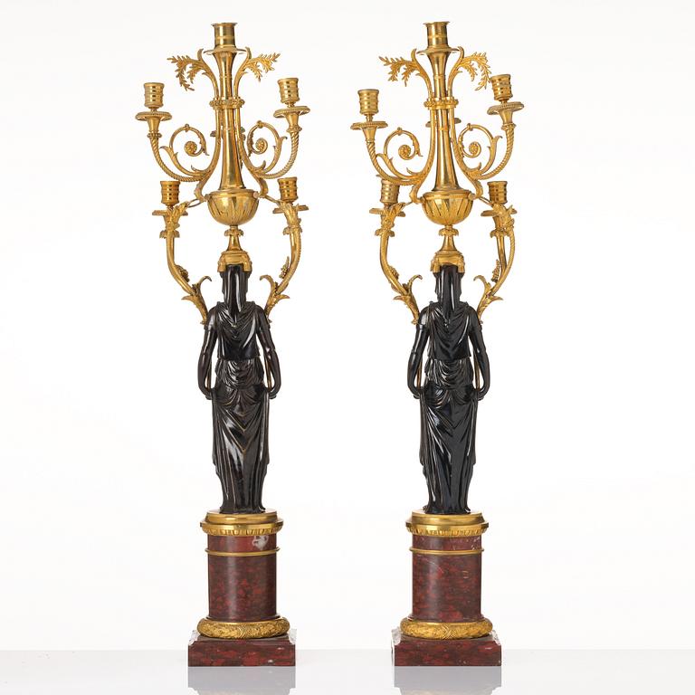 A pair of Louis XVI ormolu and patinated bronze six-branch candelabra attributed to François Rémond, late 18th century.