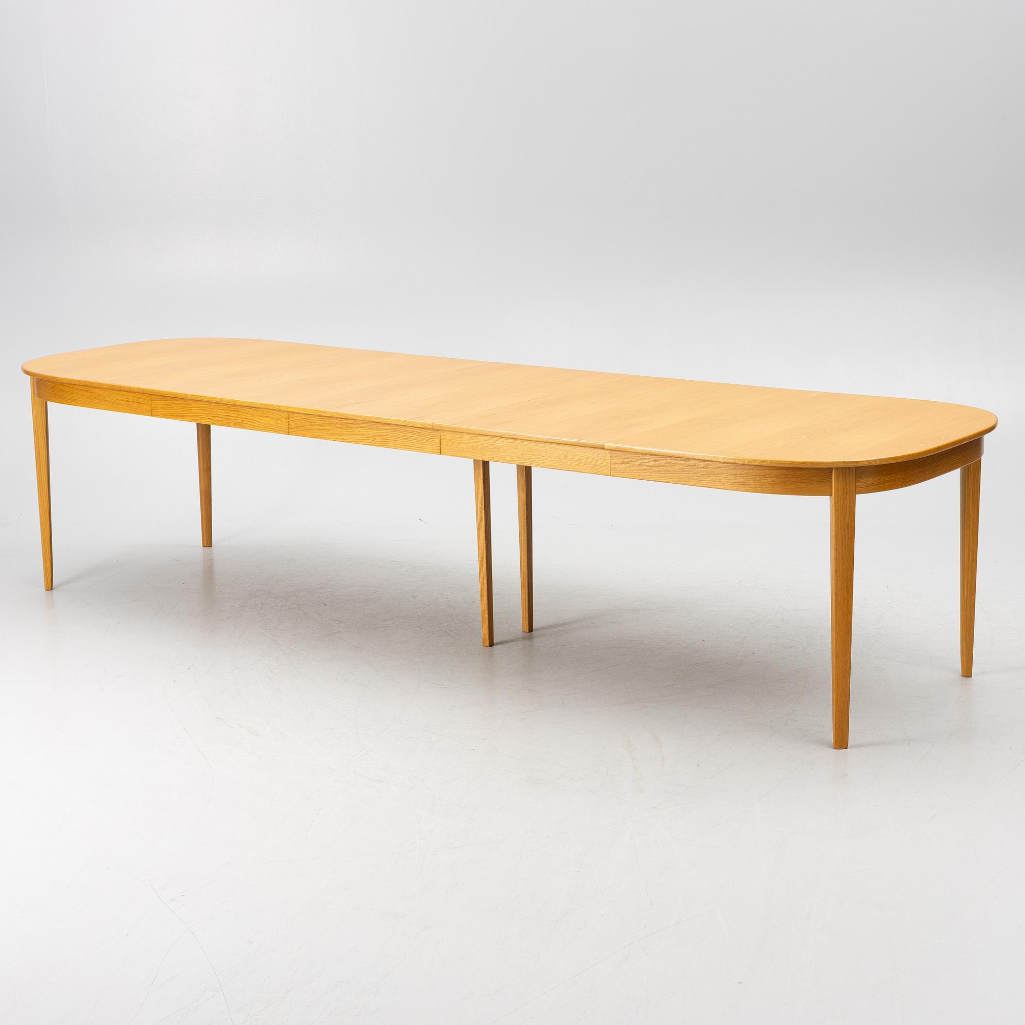 Carl Malmsten, a dining table with eight chairs, 'Camlare Nyckel', Sweden, second half of the 20th century.