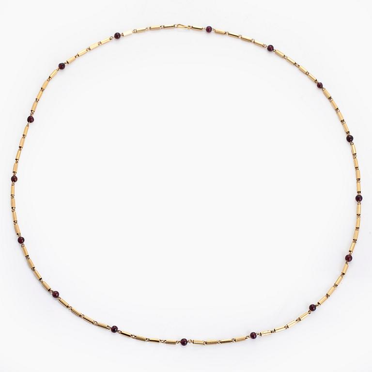 A 16K gold necklace with garnets.