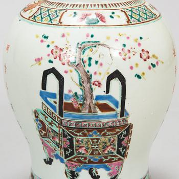 A pair of famille rose jars with covers, China, early 20th Century.