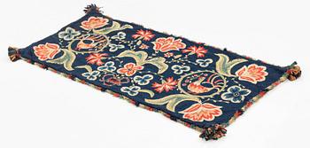An embroidered carrige cushion, ca 108 x 48 cm, signed AMA, Scania, first half of the 19th century.