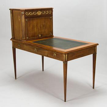 A 20th-century Louis XVI style mahogany veneered writing desk.