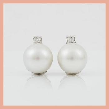 A pair of cultured South sea pearl and diamond earrings. Total carat weight of diamonds circa 0.35 ct.