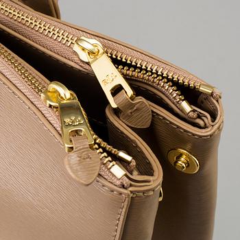 a "Newbury Double-Zip Satchel" bag by Ralph Lauren.