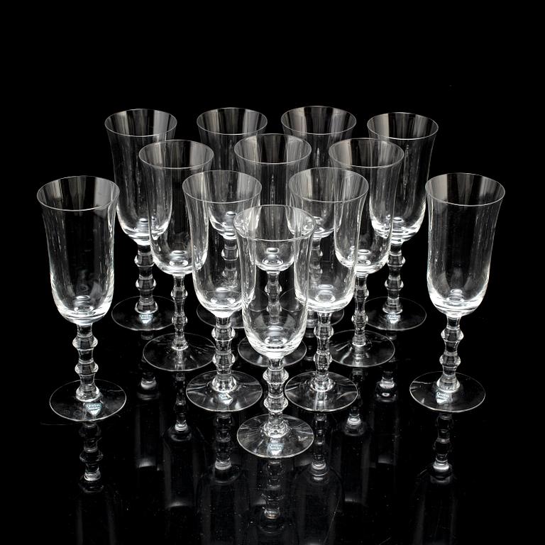 A set of twelve champagne glasses by Simon Gate.