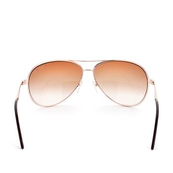 TOM FORD, a pair of gold colored sunglasses.