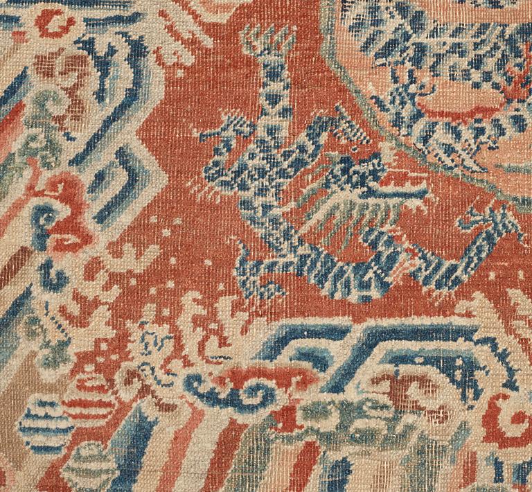 A red based Chinese five clawed dragon carpet, Qing dynasty, presumably 18th Century.