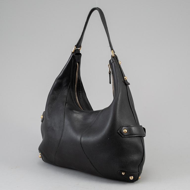 GUCCI, a leather horse-bit bag.
