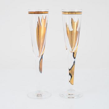 A set of 11 champagne glasses 'Goldie' by Ulrica Hydman-Vallien for Kosta Boda, Sweden.