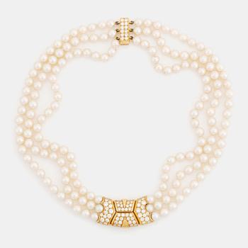 405. A Cartier triple strand cultured pearl necklace with an 18K gold clasp set with round brilliant-cut diamonds.