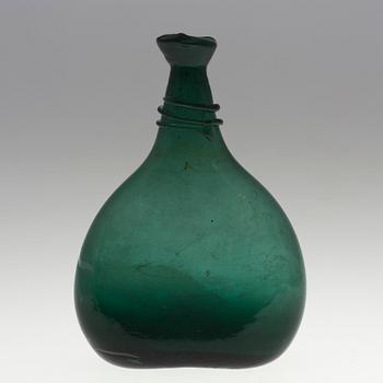 A 18th century glass bottle.