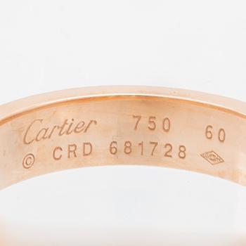 A Cartier "Love" ring in 18K rose gold with pavé-set round brilliant-cut diamonds.