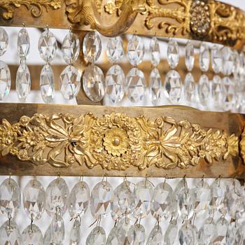 An ormolu and cut glass sixteen-branch Empire chandelier, Paris, early 19th century.