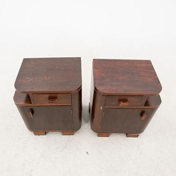 A pair of stained wood bedside tables from the first half of the 20th century.