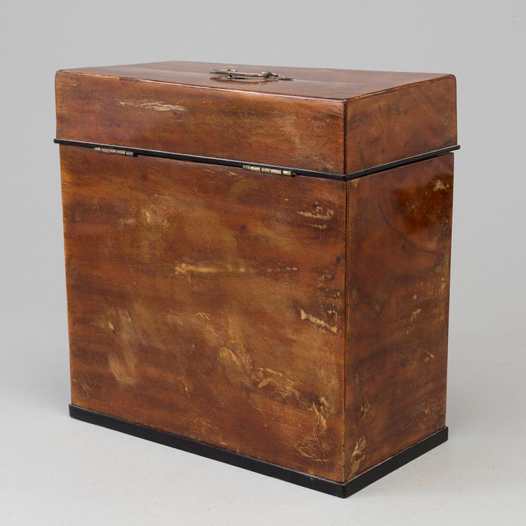 A mid 19th century mahogany veneered box with three glass bottles.