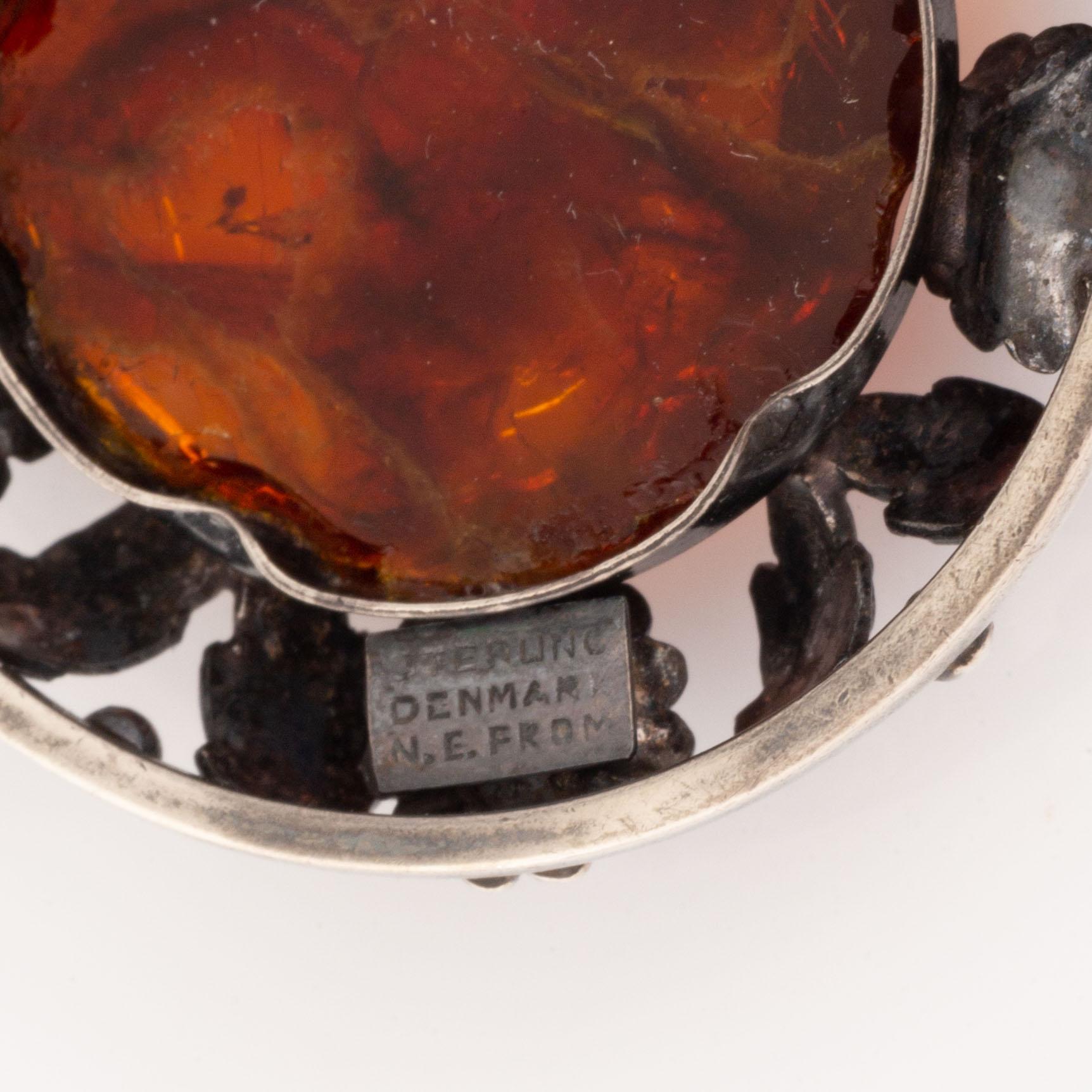 An NE From silver and amber brooch.