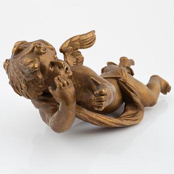 A carved and giltwood sculpture of a putto, 18th and 19th century.