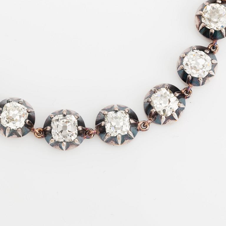 A gold and silver necklace set with old-cut diamonds.