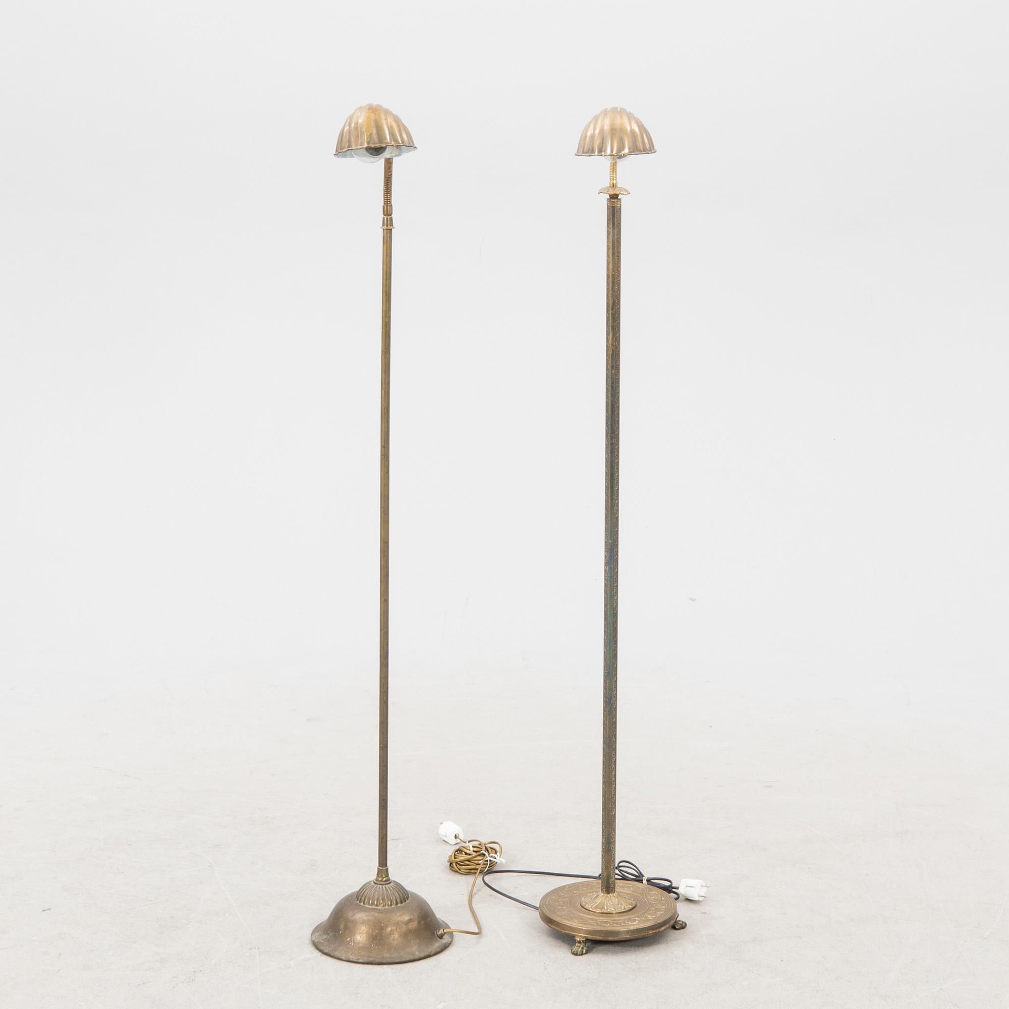 A set of two brass floor lamps later part of the 20th century.