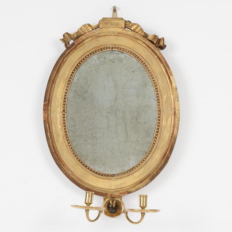 A Gustavian giltwood two-branch girandole mirror, late 18th century.
