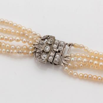 A 5-strand natural saltwater pearl necklace (one pearl cultured) Clasp with diamonds. Certificate from GCS.