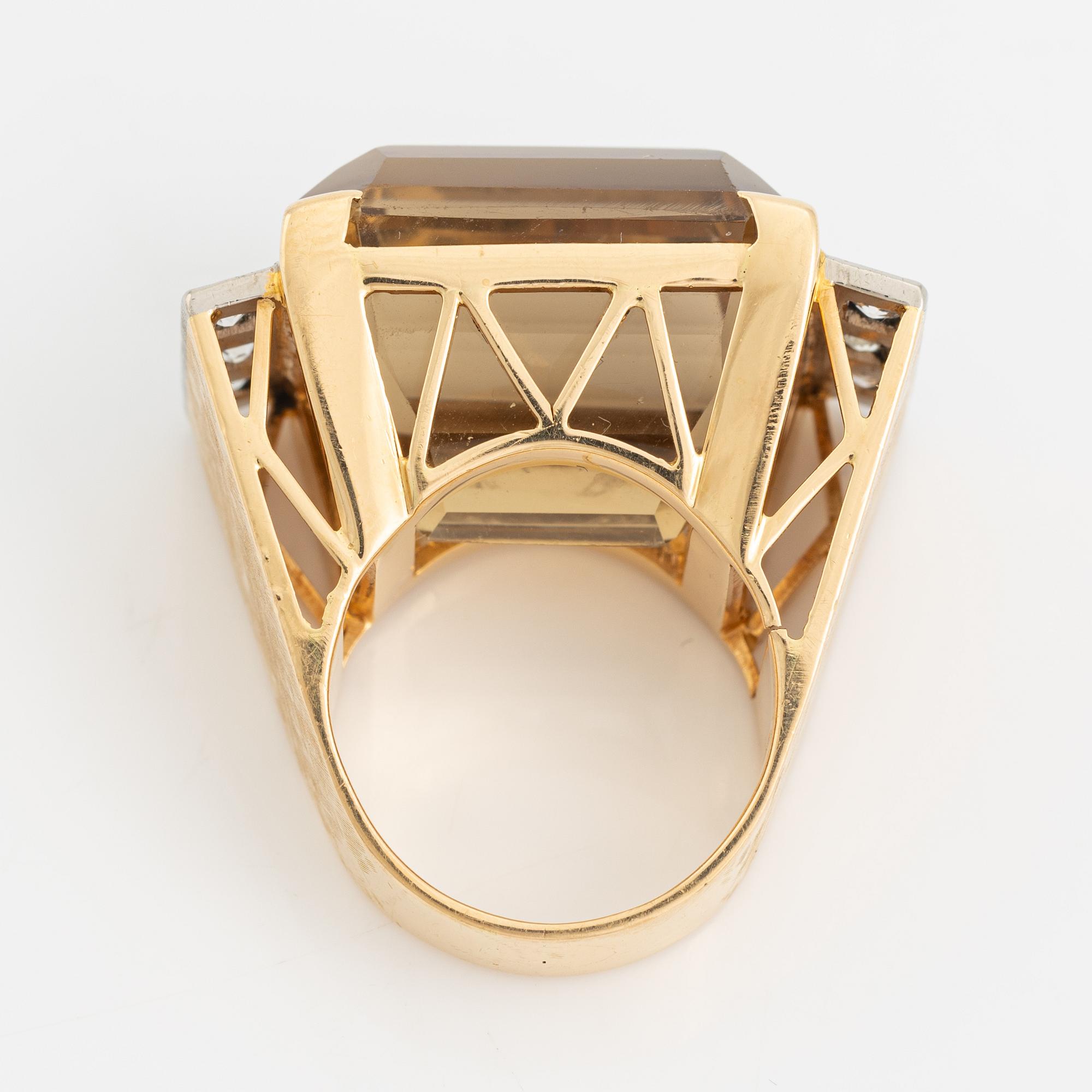 An 18K gold ring set with faceted quartz and old-cut diamons.