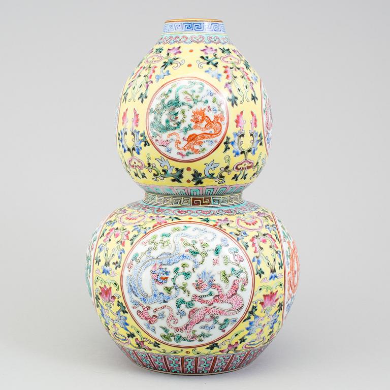 A chinese famille rose double gourd vase. Second half of the 20th century, with Qianlongs mark to the base.