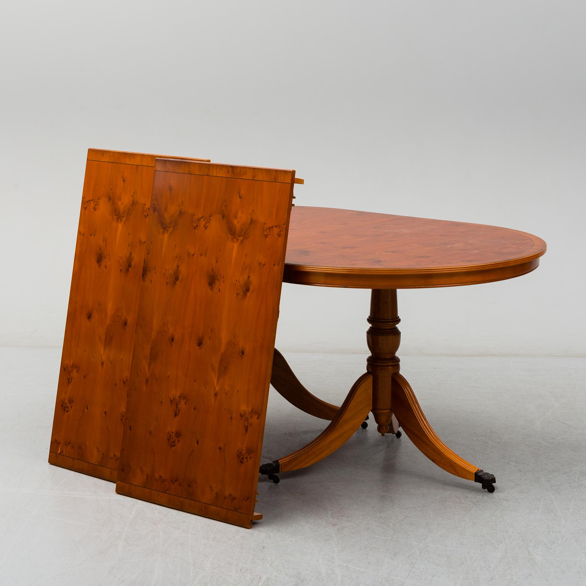 A late 20th century English style dining table and six chairs.