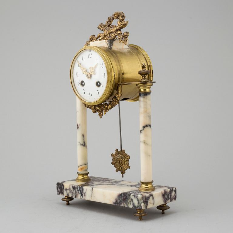 A marble and brass pendulum clock, first half of the 20th century.