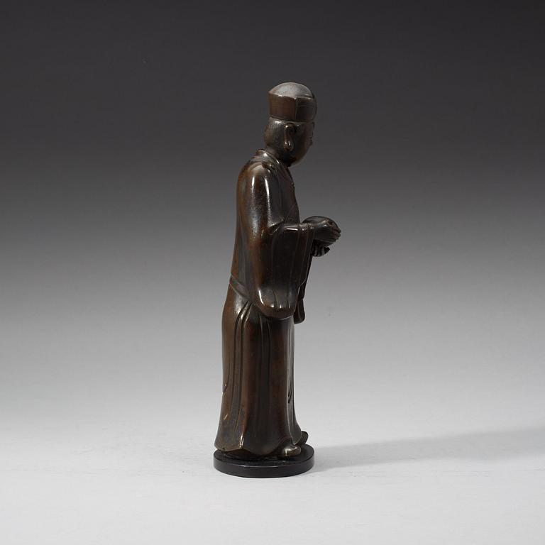 A bronze figure of a Mandarin official with a box, Qing dynasty, 19th Century.