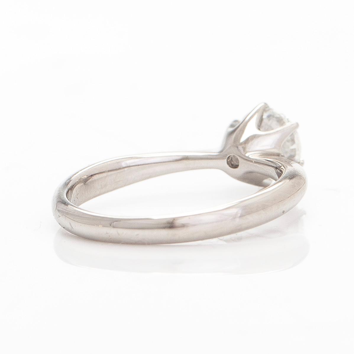 A platinum ring, with a brilliant-cut diamond approximately 1.00 ct according to the engraving.