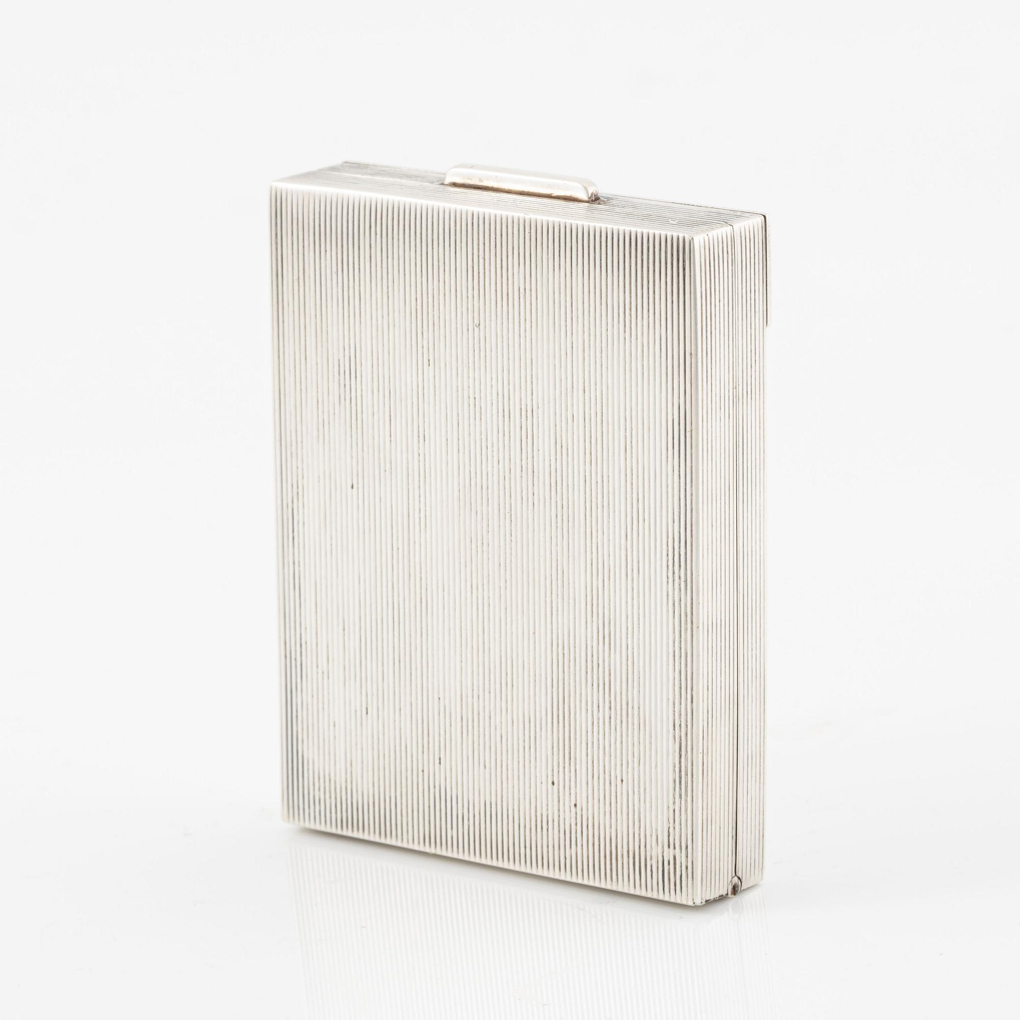 Powder box, signed Cartier, sterling silver and 14K gold with three sapphires.