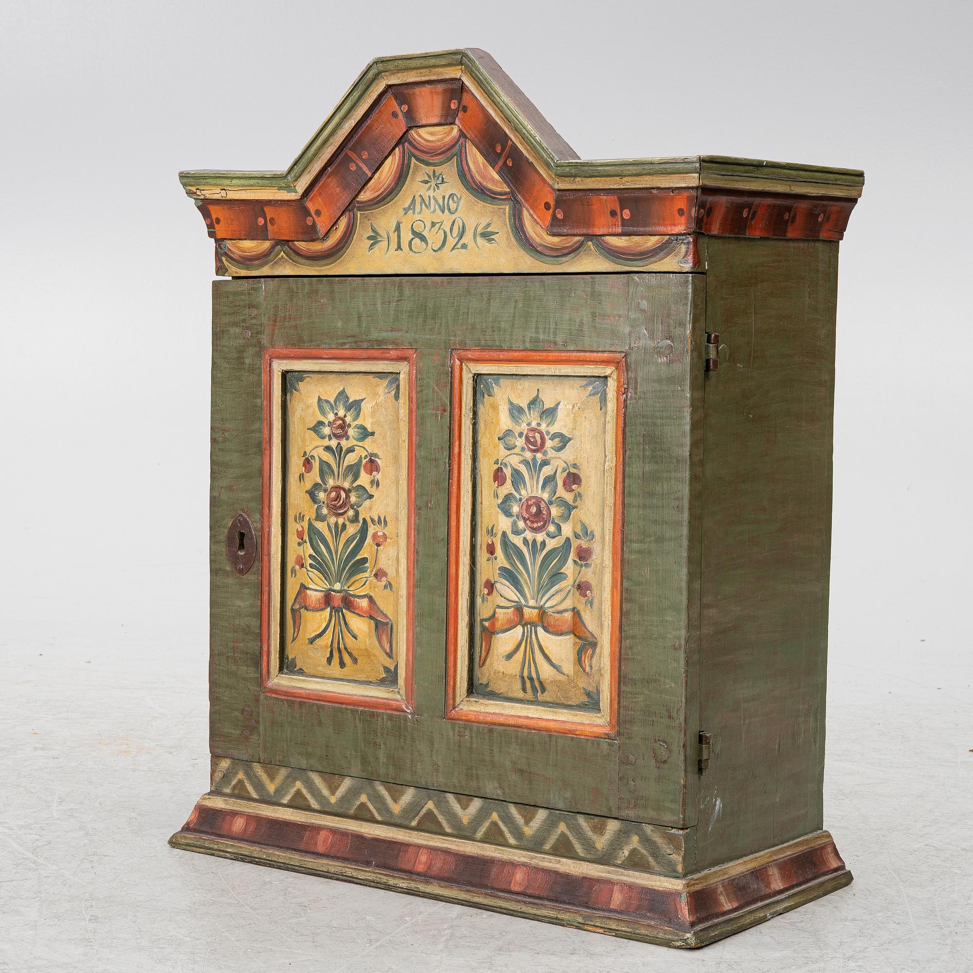 A hanging cabinet, dated 1832.