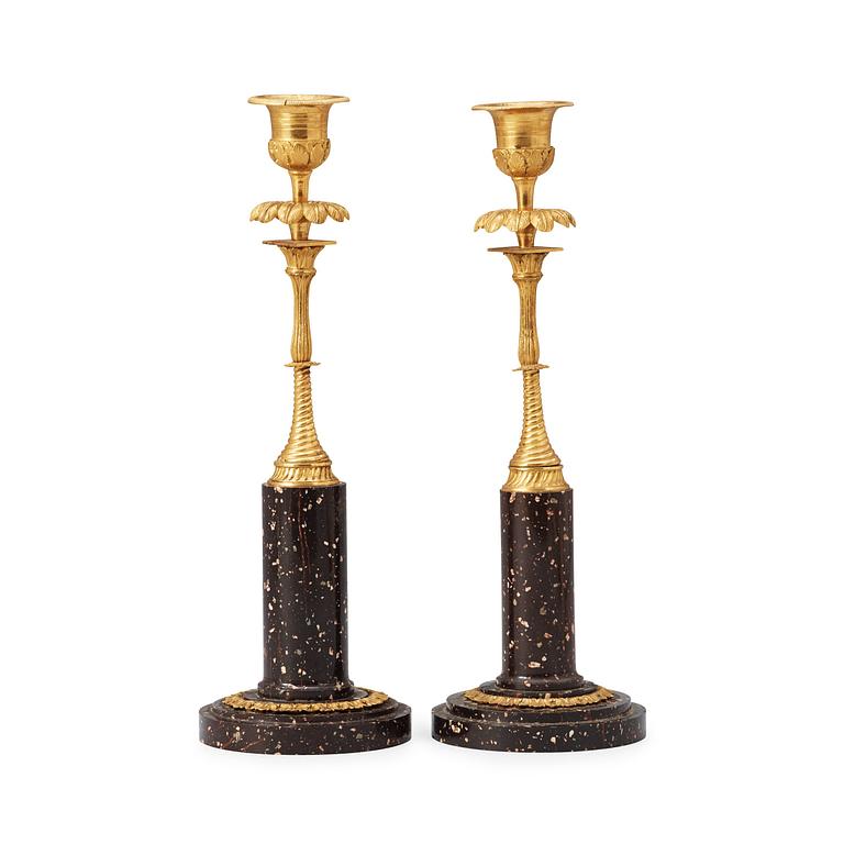 Two matched late Gustavian early 19th century porphyry and gilt bronze candlesticks.
