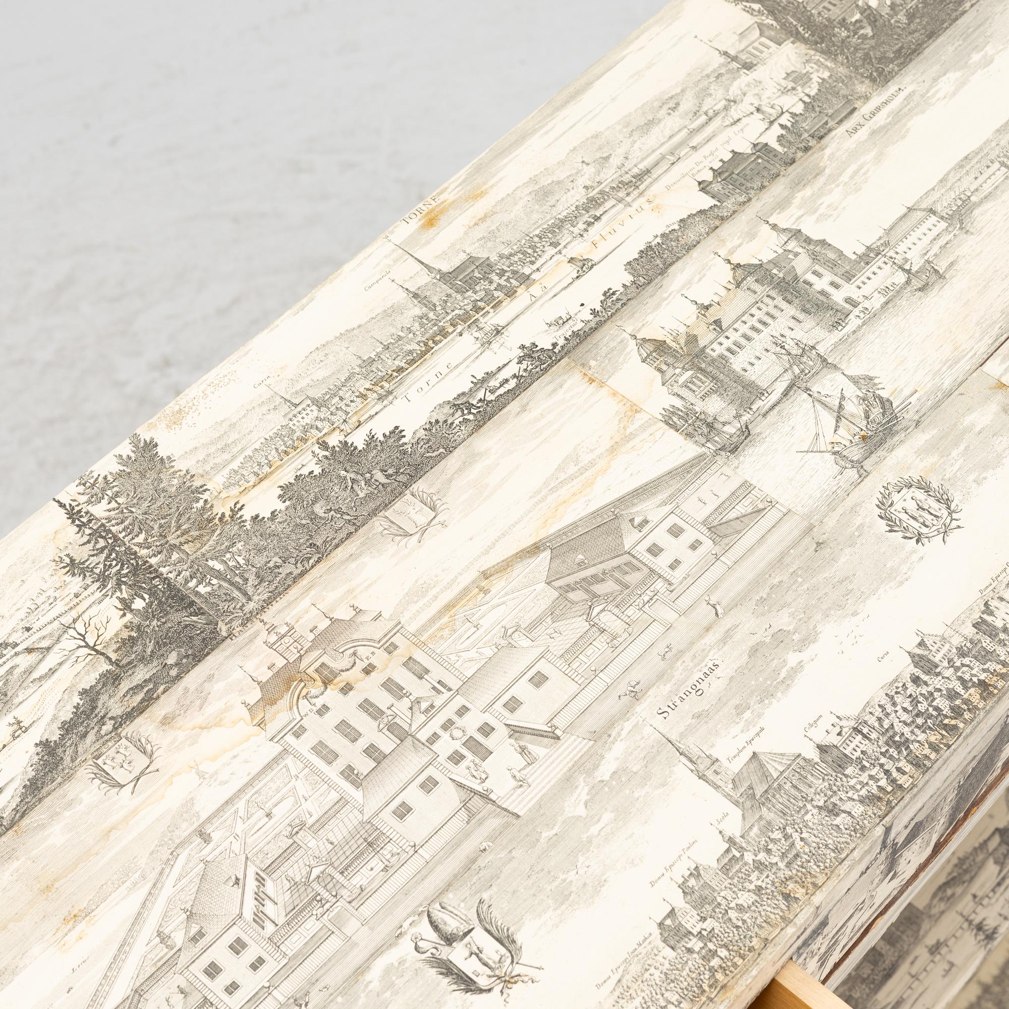 A bookcase decorated in prints from Dahlbergs Suecia antiqua et hodierna, mid 20th century.