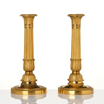 A pair of French Empire gilt-bronze candlesticks, early 19th century.