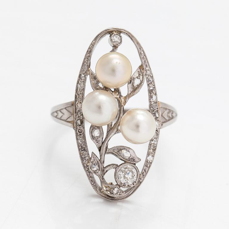 A platinum ring with old- and rose-cut diamonds and cultured pearls.