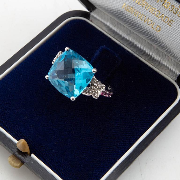 Ring, 14K gold with topaz, diamonds, and purple garnets.