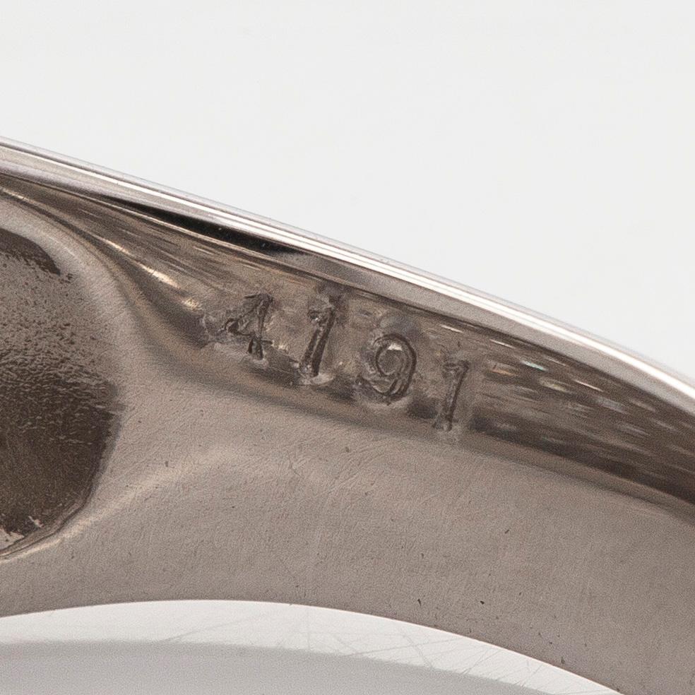 A platinum bombé ring with brilliant-cut diamonds.