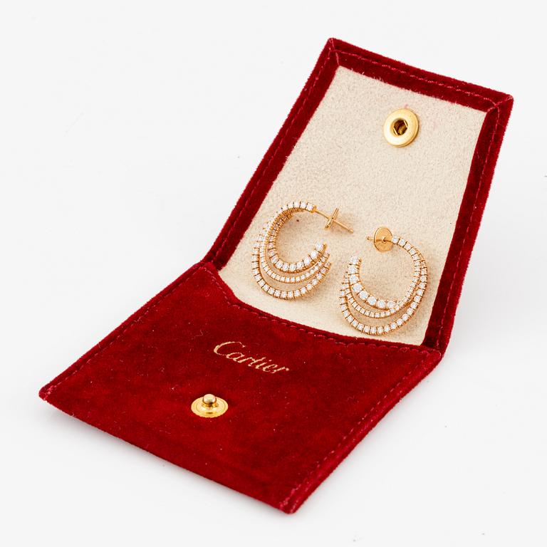 A pair of Cartier earrings in 18K gold set with round brilliant-cut diamonds.
