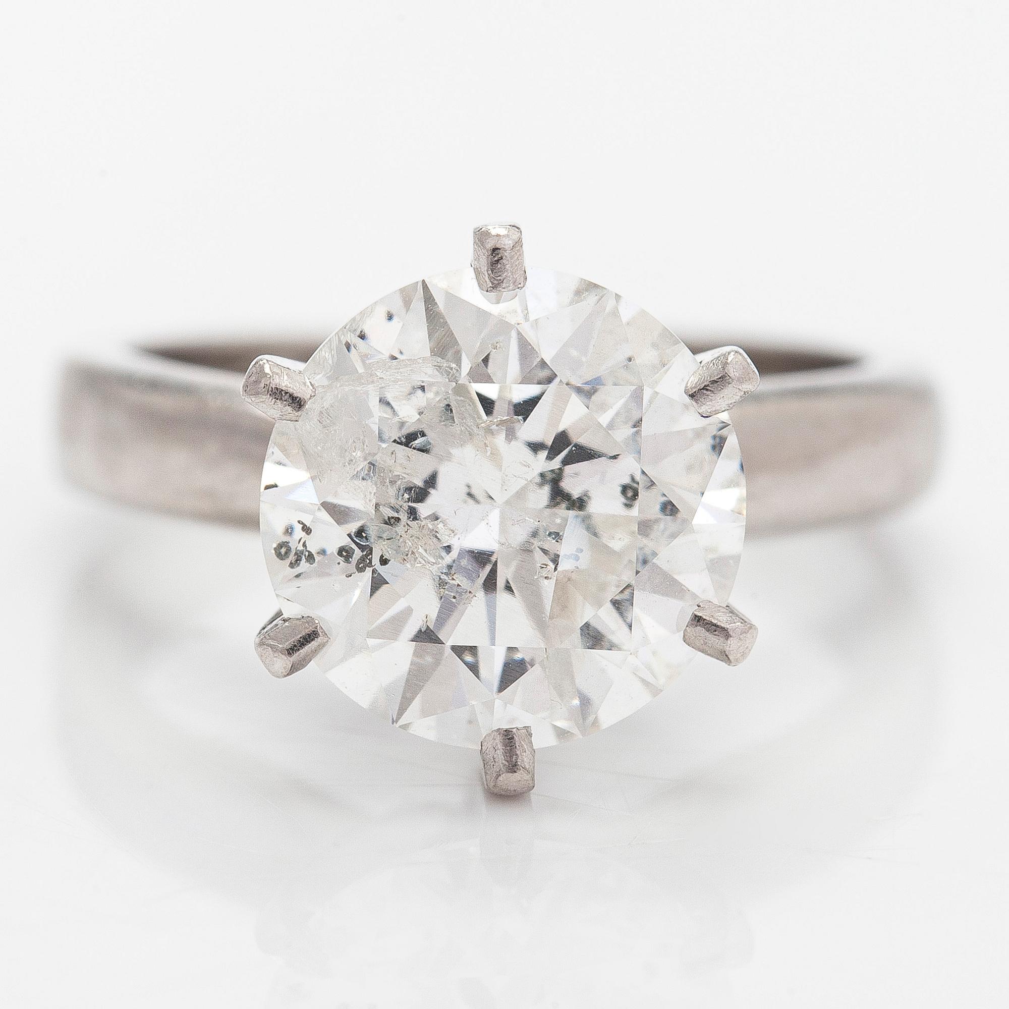 A platinum ring, with a brilliant-cut diamond approximately 3.10 ct. Domino Jewellery, Birmingham, England.