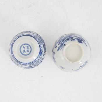 Two Chinese blue and white porcelain teacups with saucers, and two bowls, Qing dynasty, 18th and 19th century.