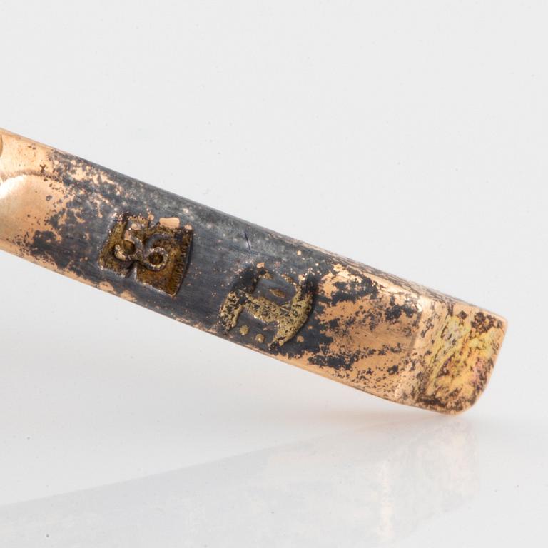 A brooch in 14K gold and silver set with old-cut diamonds, in the shape of a lily-of-the valley twig.
