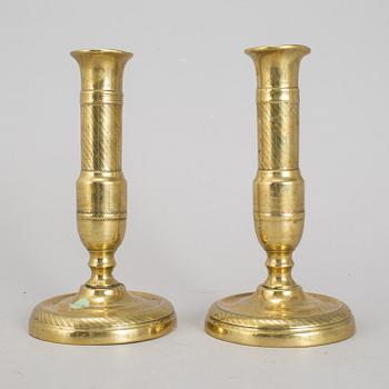 A 19th Century pair of brass candlesticks.